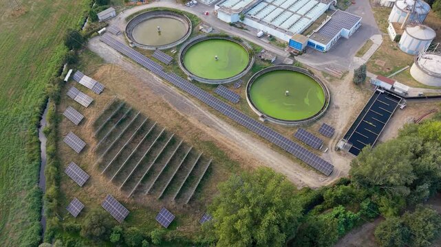 Aerial scene wastewater facility with photovoltaic infrastructure, representing renewable energy adoption, efficient utilities, and sustainable urban resource management. Milan, Assago, Italy