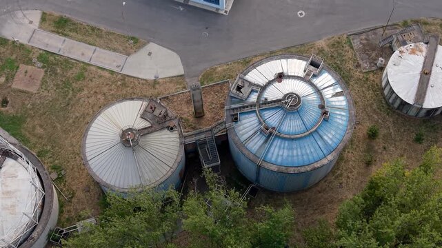 Aerial establishing view of anaerobic digesters within a treatment complex in Assago, Italy. 