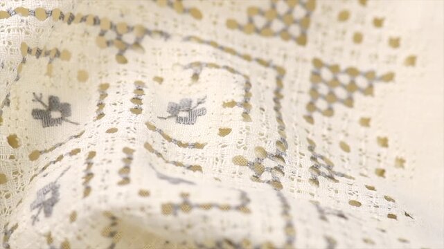 Cross stitch on linen fabric, handmade cross-stitch texture background, lace, natural eco folded linen tablecloth. Bio textile material backdrop, canvas top view, close up, rotating 