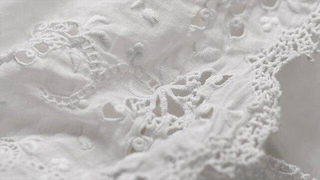 Handmade embroidered lace close-up, rotating background, top view, vintage, hand made. details of vintage blouse with hand embroidery, rotating, slow motion