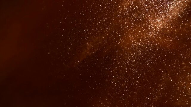 Gold particles floating background, magic dust, Liquid gold, golden abstract backdrop. Golden abstract backdrop. Beautiful metallic yellow texture, paint close-up. Art Wallpaper surface. Christmas