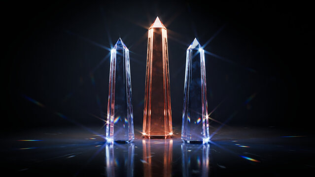 : Three tall crystal obelisks glowing in blue and orange light standing on a reflective dark surface.