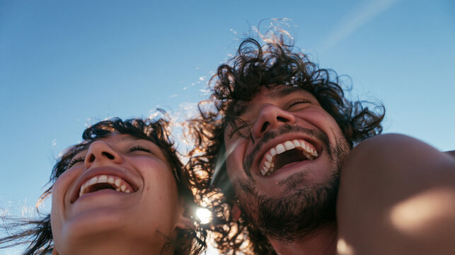 Joyful Couple Laughing Together Outdoors Under Blue Sky