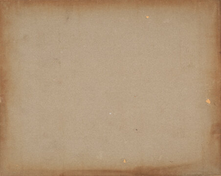 Antique brown cardboard paper texture background with dark stained edges, weathering, and vintage patina. Rustic grunge backdrop.