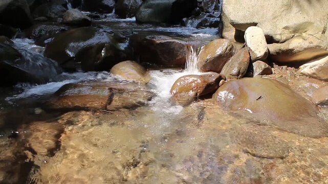 Water moves steadily across a rocky bed, its sound unbroken and consistent from one frame to the next. Many use ambient sounds like this to settle into a state of open, undistracted creative work.