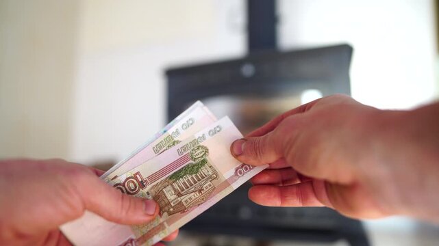 Heating payment. Russian ruble banknotes for payment of heating firewood. Russian bill money pay for heating costs in heating season. Heat house in Russia
