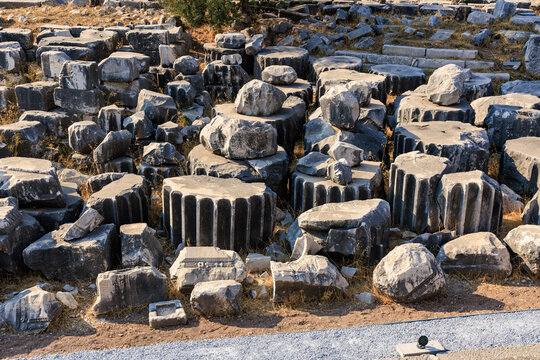 Ancient Greek ruins with doric columns remnants in outdoor archaeological site
