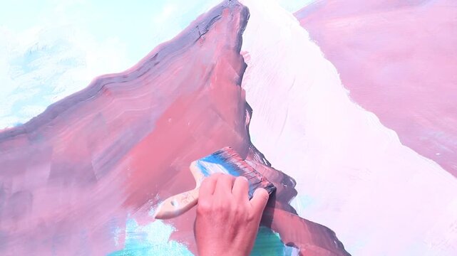 Hands painting on the wall with a brush