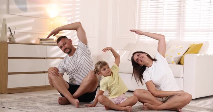 Happy family doing morning exercise together at home