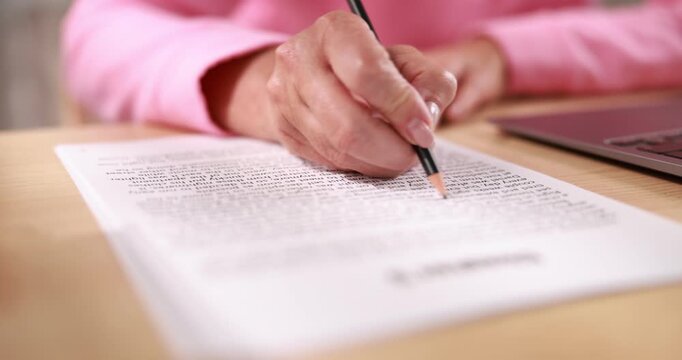 Writer working on her book at desk in office, closeup