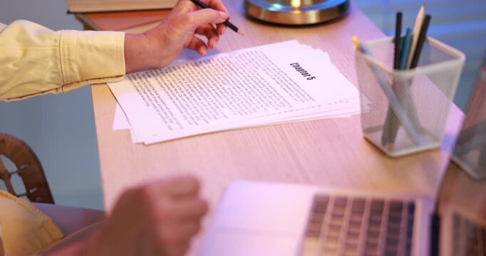 Writer working on her book in office, closeup