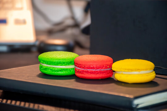 macaroons on a wooden table, Colorful Green Red and Yellow Macarons