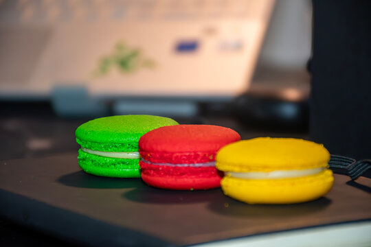 french macaroons on a wooden table, Three Bright Colorful Macarons