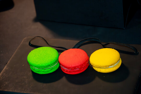 red and green macaroons on black background, Green Red and Yellow Macarons