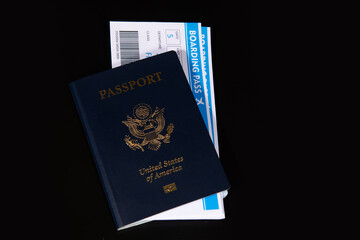 US passport with boarding pass for travel. Travel documents for international trip. Airport check in concept. American passport and airline tickets. Vacation and travel theme. © Svitlana