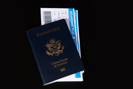 US passport with boarding pass for travel. Travel documents for international trip. Airport check in concept. American passport and airline tickets. Vacation and travel theme.