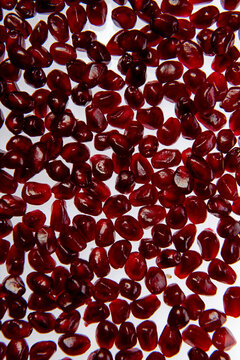 Pomegranate seeds macro background. Red ruby pomegranate arils close up background. Pomegranate arils background. Pomegranate seeds detail for background.