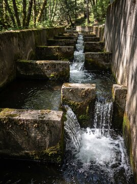 Water stepping down between baffles in a concrete fish pass