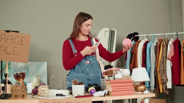 Young Woman Choosing Kitchenware, Taking Photo of Used Second Hand Recycled Sustainable Things. Charity Shop and Garage Sale, Recycling Eco New Life, European Store. 