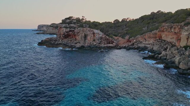 Aerial travel fooatge of waves crashing on shore, Spanish coastline, Mallorca coast. Summer, travel,vacation concept. 