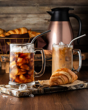 Glasses of freshly made iced coffee served with butter croissants. 