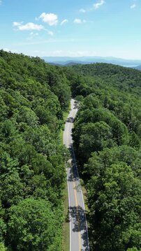 Aerial view overlooking a road winding through Oconee State Park with the foothills in the background in northwest South Carolina.