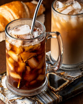 Glasses of homemade iced coffee served with croissants.