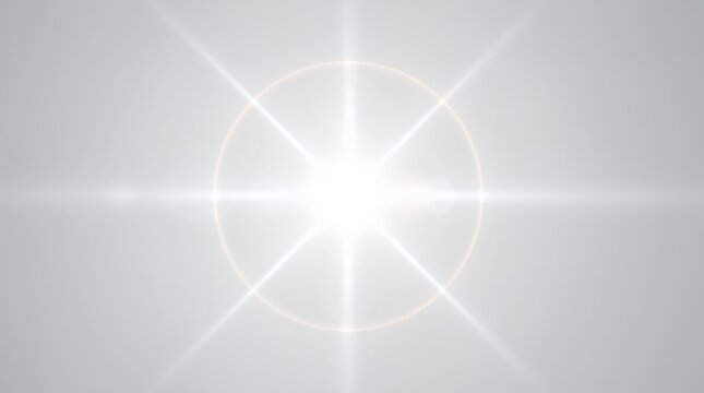 Bright white light with a circular halo and radiating starburst effect on a gray background.