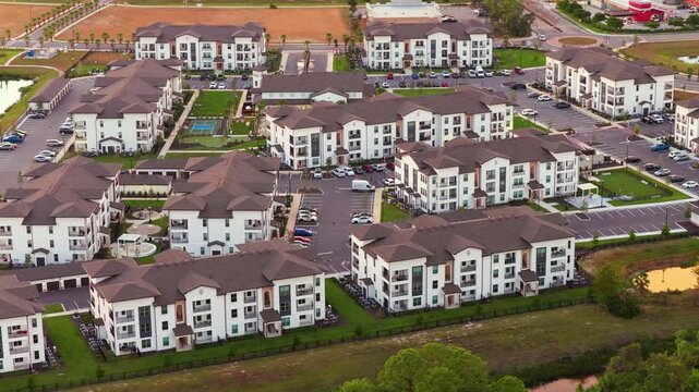 American condominium buildings in Florida suburb at sunset, reflecting real estate investment and residential planning in the region.