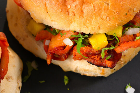 Detailed macro view of Mexican style cemita al pastor