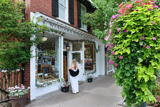 Queen Street in the town of Niagara-on-the-Lake, Ontario, has quaint stores in buildings dating from the early 1800s, with profuse floral decorations in summer