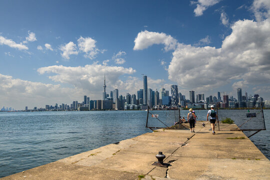 Toronto city skyline viewed from a disused pier on the Toronto Islands under dramatic summer clouds in August