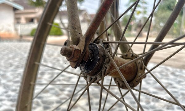 Close up shot of an old rusty bicycle hub and spokes with realistic weathered texture details