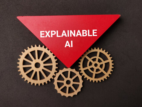A inverted red triangle labeled EXPLAINABLE AI rests above three interlocking wooden gear cogs on black