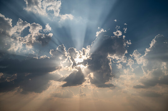 Majestic Sunburst Cloudscape with God Rays Bursting Through Dark Clouds.