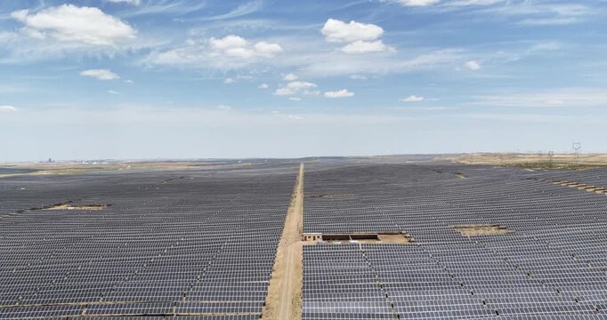 Aerial Video of Vast Solar Farm with Dirt Road in Gobi Desert Ningxia, China.