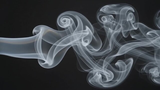 Abstract flowing white smoke trails isolated on a solid black background for artistic design projects