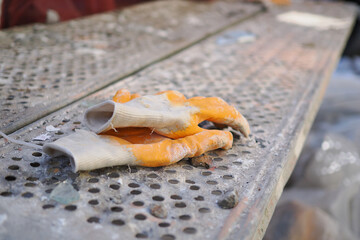 Workers leave dirty gloves on a table at a construction site
