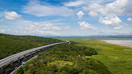 Fototapeta premium Drone shot The M6 motorway Nakhon Ratchasima Province - Bang Pa-in Lam Ta Khong River and Mountain. Motorway Korat Thailand