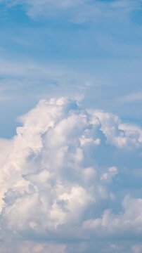 Peaceful daytime sky time-lapse with soft white clouds flowing in a deep blue atmosphere.