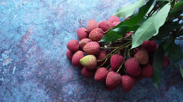 Fresh lychee fruits on blue background