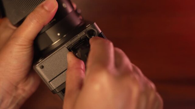 Extreme close up shot of woman hands plugging HDMI cable into camera port and unplugging, video production and technology connection concept.