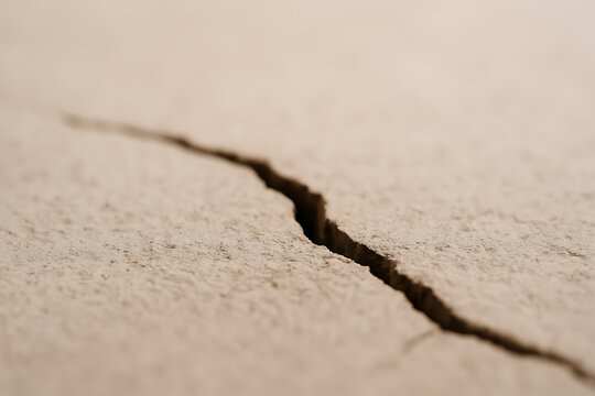 Close up of a cracked dry surface showing deep fracture and texture