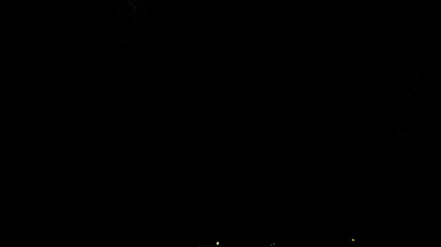 Vast expanse of a deep black background features minimal, faint light specks emerging from the bottom edge, creating an abstract and mysterious dark void with extensive copy space.