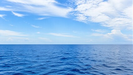 Fototapeta premium Open ocean with calm surface under blue sky horizon