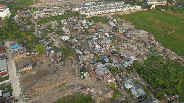 Slum Village Made Of Trash And Scrap Near Legian Seminyak Poverty In Urban Bali Indonesia Drone Static 4K 60FPS