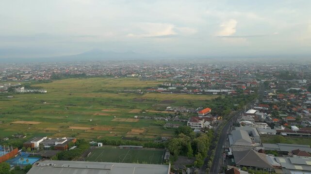 Urban Sprawl Downtown Kuta Legian Bali Indonesia Overpopulation Drone Track Left 4K 60FPS