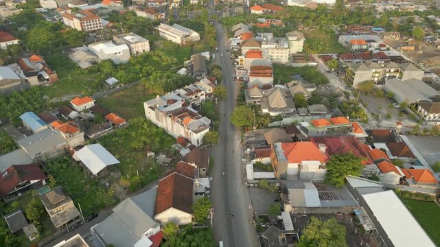 Houses Hotels And Early Morning Traffic Peaceful Street Legian Bali Indonesia Drone Track Overhead 4K 60FPS