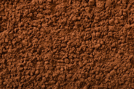 Food background of raw cocoa powder, top view.