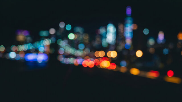 漆黒の空間で整列を始める赤と黄の玉ボケと都市夜景の初期状態抽象背景